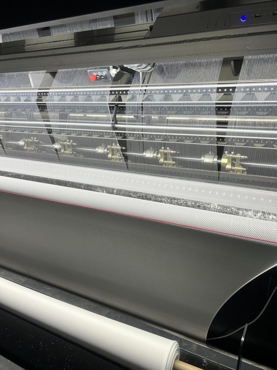 Tricot machine for garment production